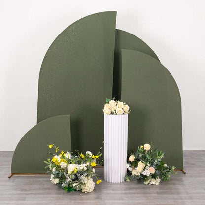 Green abstract backdrop with white pedestal and floral arrangements.
