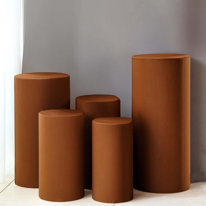 Set of five modern brown cylindrical stools on a neutral background.