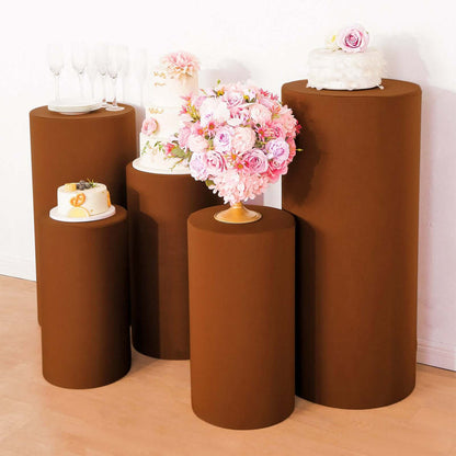 Brown cake stands with floral arrangements and desserts for event displays.