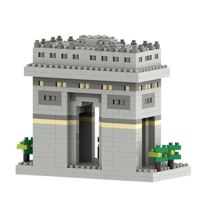 The Brixies Small Gift Box Arc De Triomphe is a micro-brick model of the Paris landmark, featuring a central archway, yellow stripe, and green trees—an elegant tribute constructed from gray bricks.