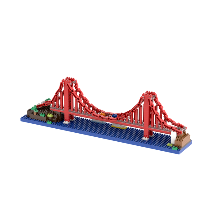 The Brixies Small Gift Box Golden Gate Bridge is a micro-brick construction kit featuring a miniature red suspension bridge over a blue water-like base with green and brown blocks at each end.