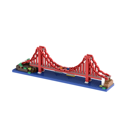 The Brixies Small Gift Box Golden Gate Bridge is a micro-brick construction kit featuring a miniature red suspension bridge over a blue water-like base with green and brown blocks at each end.