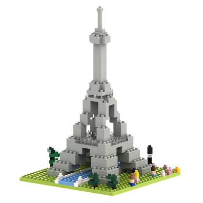 The Brixies Small Gift Box Large Eiffel Tower features a detailed micro-brick model on a green base with trees, flowers, and a river, bringing Parisian charm to any space.
