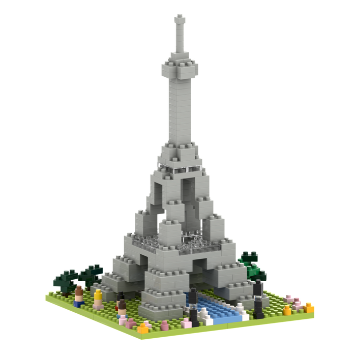 Build Parisian charm with Brixies’ Small Gift Box Large Eiffel Tower: a gray micro-brick model on a square base, accented by green, pink, and yellow trees and flowers plus a blue river in front.