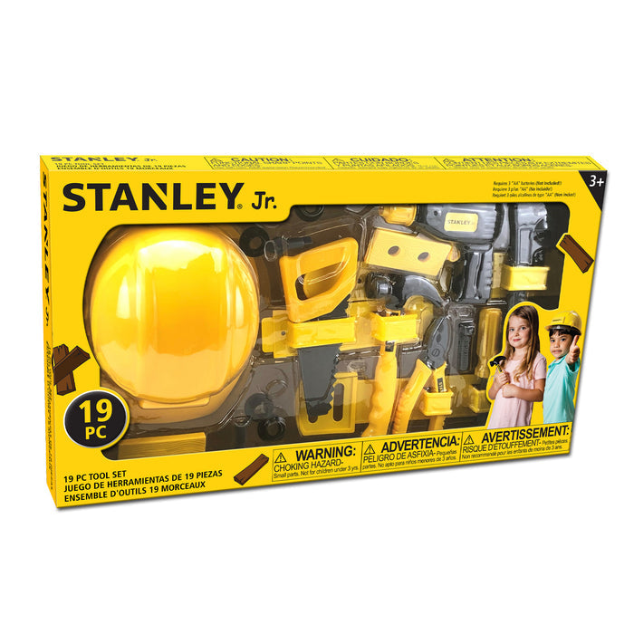 The Red Toolbox Stanley Jr. 19 Piece Pretend Play Tool Set comes in yellow and black packaging with a kid-sized toolbox, toy hard hat, tools, images of kids in construction hats, safety warnings on the box, and is suitable for ages 3+.