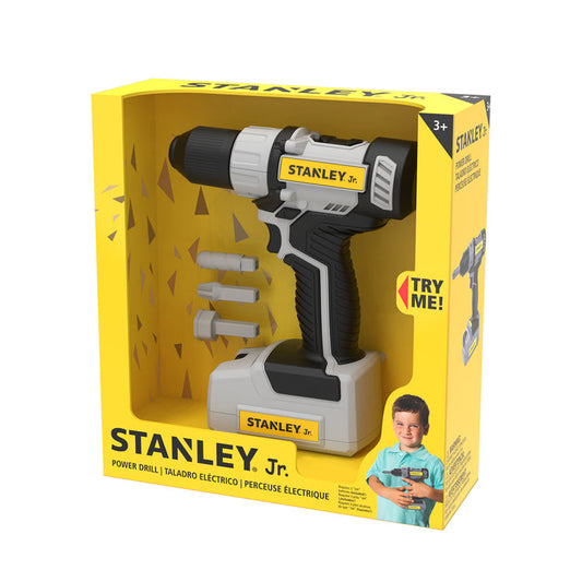 The Red Toolbox Stanley Jr. Power Drill comes in yellow packaging with a kid-friendly tool, two drill bits, and a photo of a smiling child using the toy. "Try Me!" is printed on the box. Suitable for ages 3 and up.
