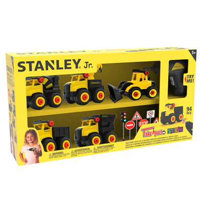 A yellow and black Red Toolbox Stanley Jr. Take Apart Dot 5 Piece Set box for ages 3+, featuring four construction vehicles, a battery-operated screwdriver, traffic signs, cones, and a smiling child holding a toy.
