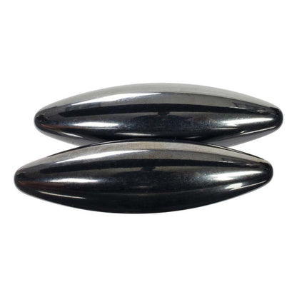 Two shiny, oval Toy Science Magna Buzz hematite magnets by Toy Science lie parallel on a white background. Their smooth, reflective surfaces are ideal for use as a magnet toy or hands-on STEM science activities.