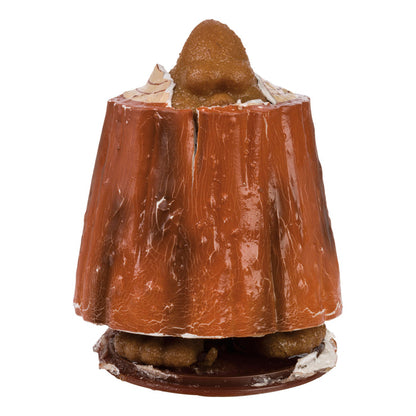 A tree stump cake with a realistic nose on top, pastries at the base, and the Toysmith Grow Bigfoot toy from Toysmith for a whimsical touch, all set against a white background.