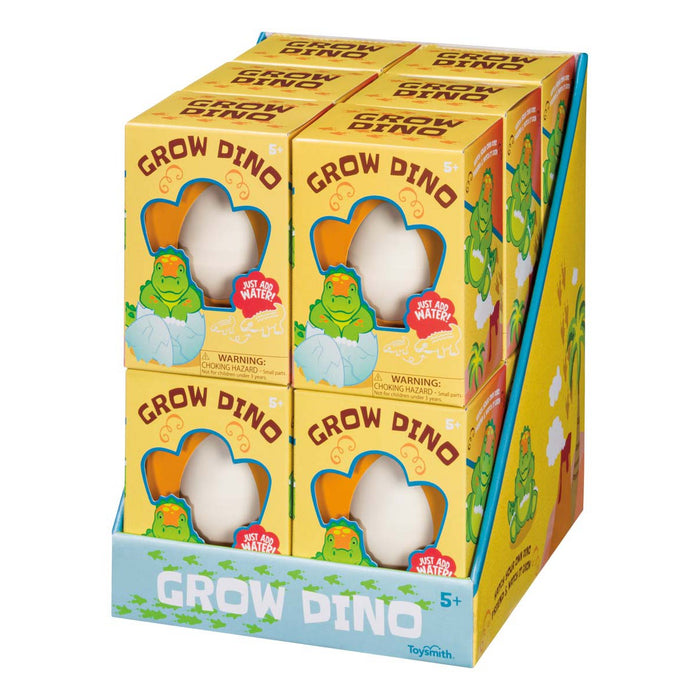 The Toysmith Hatchin' Grow Dino display box features fun, expanding dinosaur toys in colorful packaging with cartoon dinosaurs and the phrase "Just add water!"—perfect for kids who love surprise and discovery. Brand: Toysmith.