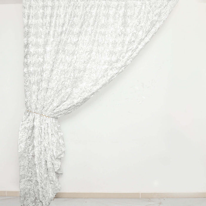 Elegant silver rose-patterned curtain draped on a white backdrop.