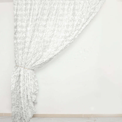 Elegant silver rose-patterned curtain draped on a white backdrop.